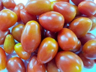 Top view of cherry tomatoes as a background (Solanum lycopersicum var. cerasiforme)