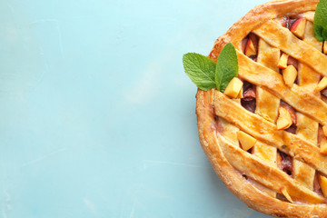 Tasty homemade peach pie on table