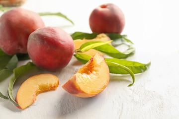 Naklejka na ściany i meble Fresh peaches on white wooden table