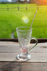 Empty glass placed on a wooden plate.
