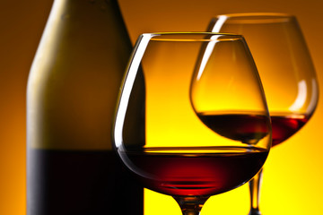  glasses of brandy on  on a yellow background