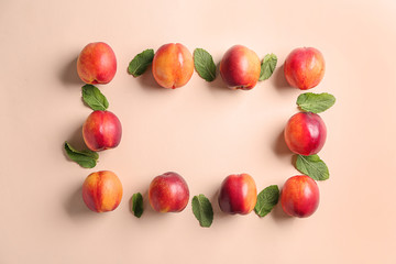 Composition with ripe peaches on color background, top view