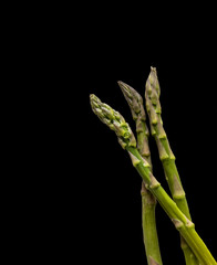 Bunch of fresh green asparagus on black background