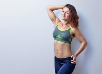 Fototapeta premium Beautiful female fitness trainer isolated on the white background.