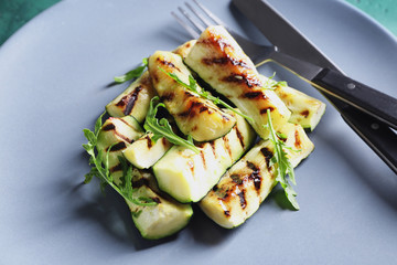 Tasty grilled zucchini on plate, closeup