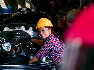 Plakat Young Asian Engineer woman working with machine in factory.