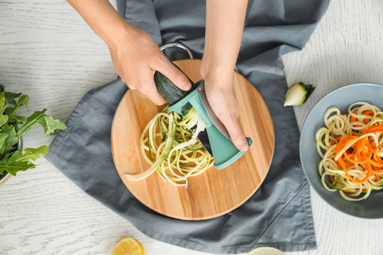 Woman making zucchini spaghetti