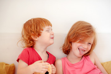 Brother and sister fooling around on the bed