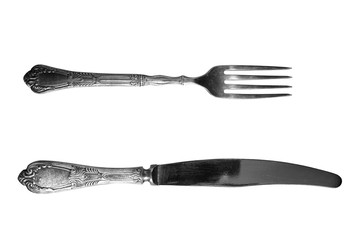 Metal fork and silver knife on a white background.