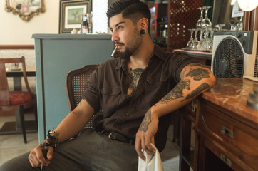 Vintage men tattooing and posing in a retro bar