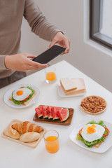 Obraz na płótnie Canvas taking photo of sandwich with smart phone