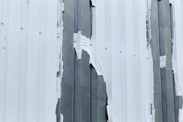 External cladding coating disbonding and flaking off exposing the galvinised steel profiled panels.