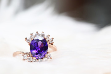 Purple gem stone on gold ring