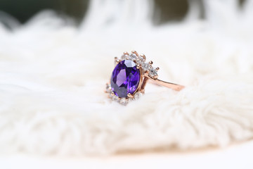 Purple gem stone on gold ring