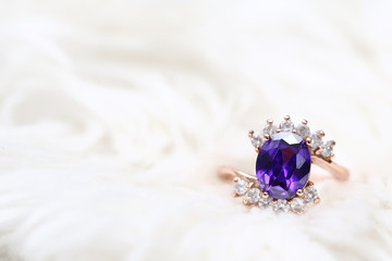 Purple gem stone on gold ring