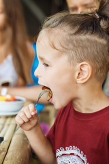boy eating pancake with banana and chocolate