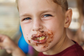 boy eating pancake with banana and chocolate