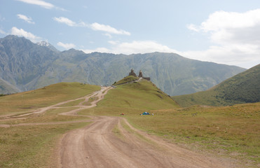 Fototapeta premium Tsminda Sameba- Holy Trinity Church near the Kazbegi-Gergeti village.The Church is situated at an altitude of 2300 meters at the foot of mount Kazbek