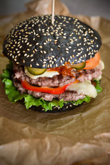 Black burger on wrapping paper