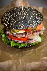 Black burger on wrapping paper