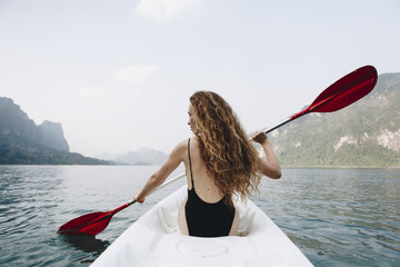 Woman paddling a canoe through a national park