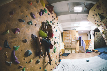 The climber trains on the climbing wall.