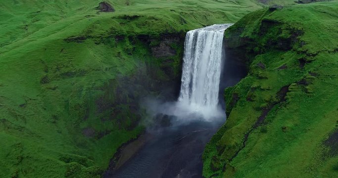 Slow motion aerial view of magnificent famous waterfall Skogafoss in Iceland