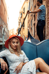 Beautiful girl enjoys riding a gondola in Venice