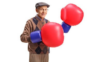 Senior wearing a pair of large boxing gloves
