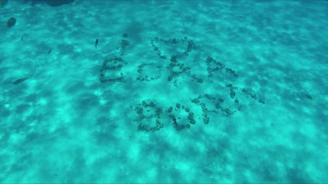 Underwater shot of  'I love Bora Bora' at the sand surface