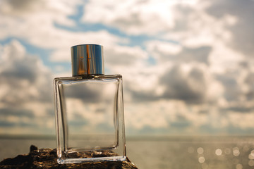 bottle of perfume on water background