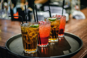 Multicolored cocktails on a tray