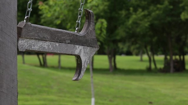 Short clip of a wooden arrow sign swaying back and forth