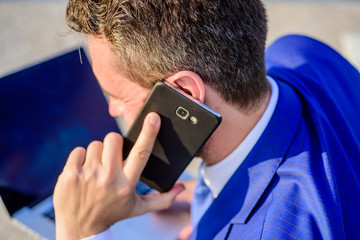 Call technical support service. Businessman holds smartphone near ear close up. Man formal suit...