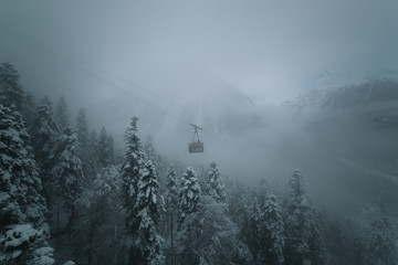 wagon lift in the background of snowy forest and mountain peaks in the fog