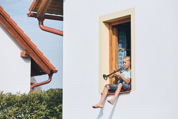 Little boy playing the trumpet