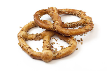 Two bavarian pretzel with sunflowers seeds isolated on white