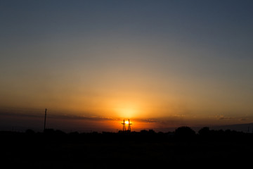 Sunset behind electric tower