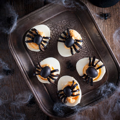 The idea for decorating a table for Halloween: stuffed eggs with spiders, top view