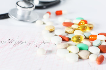 stethoscope, pills, vials in medical room on blue background top view mockup