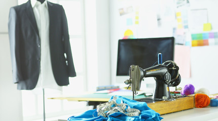 Retro sewing machine on designer clothes desktop