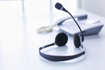 Communication support, call center and customer service help desk. VOIP headset on laptop computer keyboard