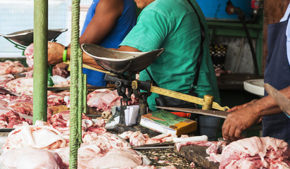 Butchers cutting meet in an outdoor market in Havana Cuba