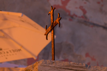 A rusty sailor's cross stands on the banks of the Croatian port city of Rovinj.