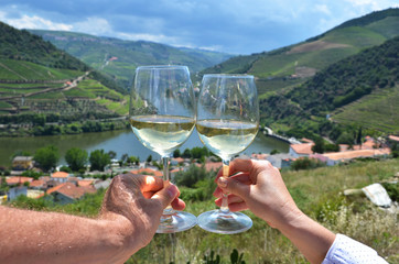 Wine glasses against vineyards in Douro Valley, Portugal