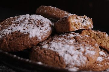 oatmeal cookies on a black table in castor sugar