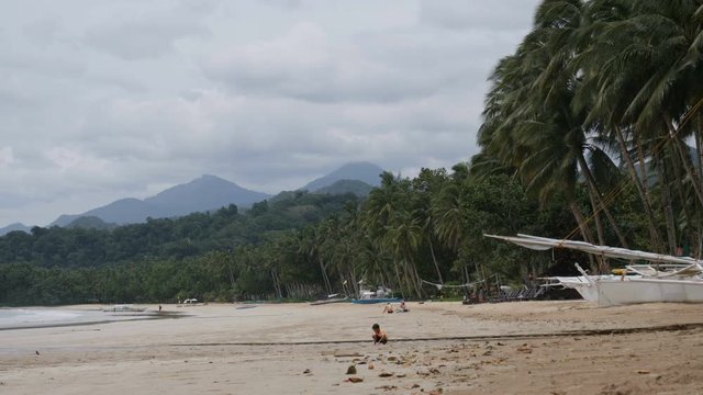 Young child playing on beach of Sabang, Palawan, Philippines