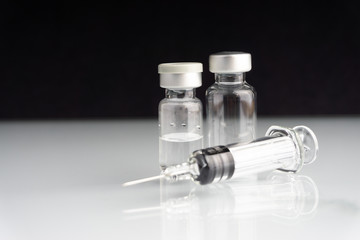 Syringe and vials closeup with selective focus and crop fragment. Medical and Healthcare Concept