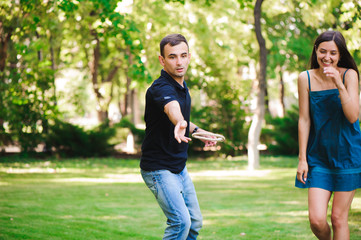 Guy and girl compete in the ring toss