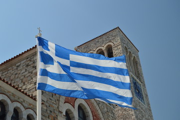 Orthodox Church Of Konstantinos With The Beautiful Blue And White Greek Flag Waving In The Wind. Architecture History Travel.4 July 2018. Volos. Magnesia. Greece.